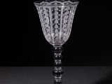 a wine glass sitting on a table with a black background