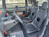 two seats in the back of a car with a steering wheel