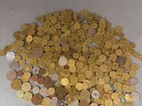 a pile of coins sitting on a white surface