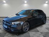 a black mercedes cla parked on a checkered floor