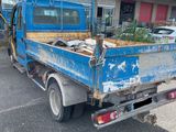 a blue truck parked in front of a building