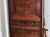 a dresser with a mirror on top of it in a room