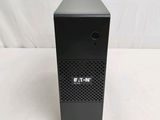 an image of a small black computer tower on a white surface
