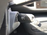 a remote control in the center of a car ' s dashboard