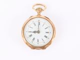 a gold pocket watch with roman numerals on the face