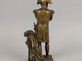 bronze statue of a man with a hat and a robe