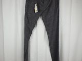 a pair of gray pants hanging on a white curtain
