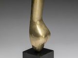 a bronze sculpture of a female torso on a black base