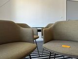 two chairs and a table in a room with a striped rug