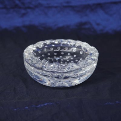a glass bowl with a black and white design on it