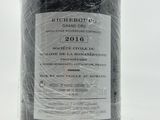 a bottle of wine that is wrapped in plastic