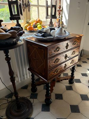a small table with a bowl of fruit on top of it