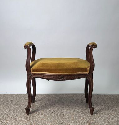 a small bench with a yellow cushion on top of it