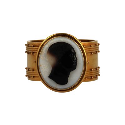 an image of a gold ring with a black and white silhouette of a man