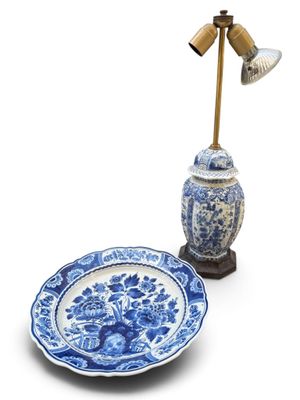a blue and white plate and a lamp on a table