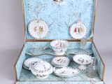 a suitcase that has a tea set inside of it