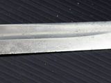 a close up of a knife on a black surface