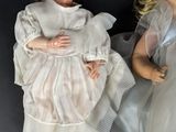 two dolls that are laying next to each other