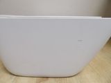 a white bowl sitting on a wooden table in a room