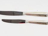 two knives that are sitting on top of each other