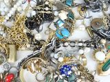 a pile of assorted jewelry sitting on a table