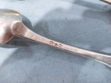 two spoons that are sitting on a table