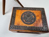 a small wooden box with a design on it