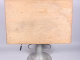 a small wooden table with a metal base on a stand