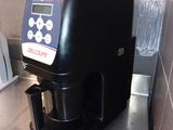 a coffee maker sitting on a counter in a kitchen