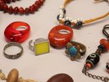 many different types of jewelry displayed on a table