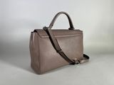 a brown leather handbag on a white background