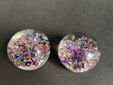 two glass plugs with colorful confetti on them