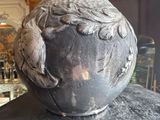 a vase with a bird on it sitting on a table
