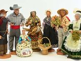 many figurines of people dressed in traditional clothing