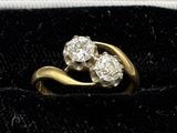 an image of a gold and diamond ring on a velvet surface