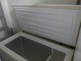 a white refrigerator with a door open in a room