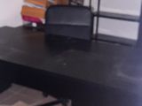 a desk with a chair and a bed in a room