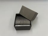 a box with a ring inside of it on a table