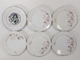 six plates with floral designs are arranged on a white surface