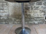 a small table with a glass on top of it