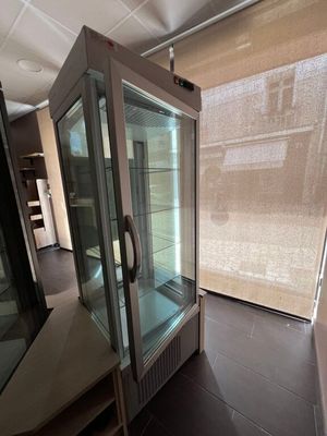 a glass display case in the middle of a room