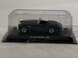 a black car in a clear case on a white surface