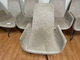four chairs and a table in a room with wood flooring