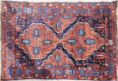 an old persian rug with a blue and red design on it