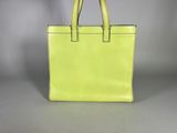 a yellow handbag sitting on top of a white table