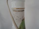 a close up of a vase with a handle on it
