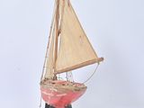 a small model of a sailboat on a stand