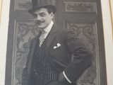 a black and white photo of a man in a suit and top hat