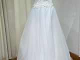 a white dress on a mannequin display in a room