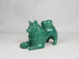 green ceramic cat figurine sitting on a white surface